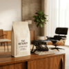 Premium bag of MadMen Coffee whole bean roast sitting on a rustic wooden desk